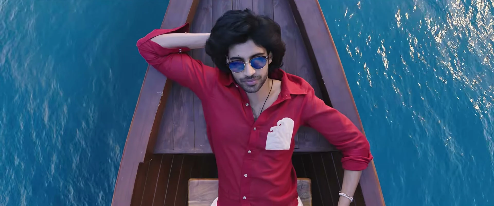 Vivasvaan in a narrow wooden boat on blue water